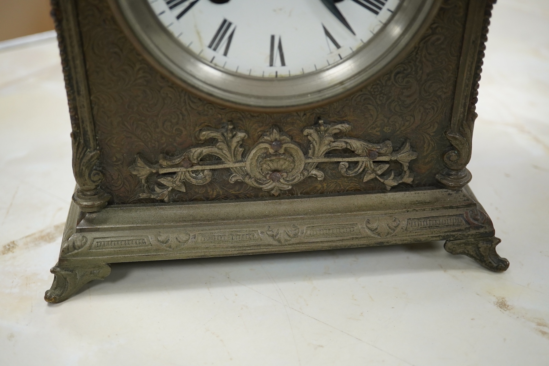 A brass overlaid mantel clock with key and pendulum, striking on a bell, 26cm high